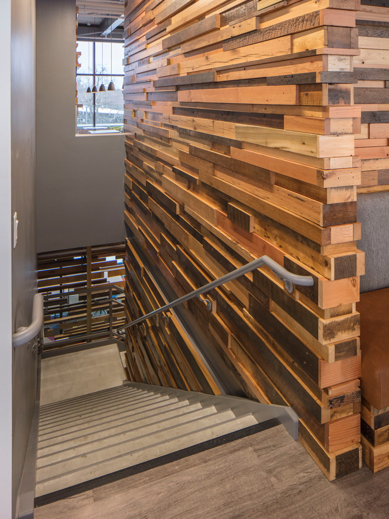 Reclaimed Wood Paneling on Walls along Workspace Stairs